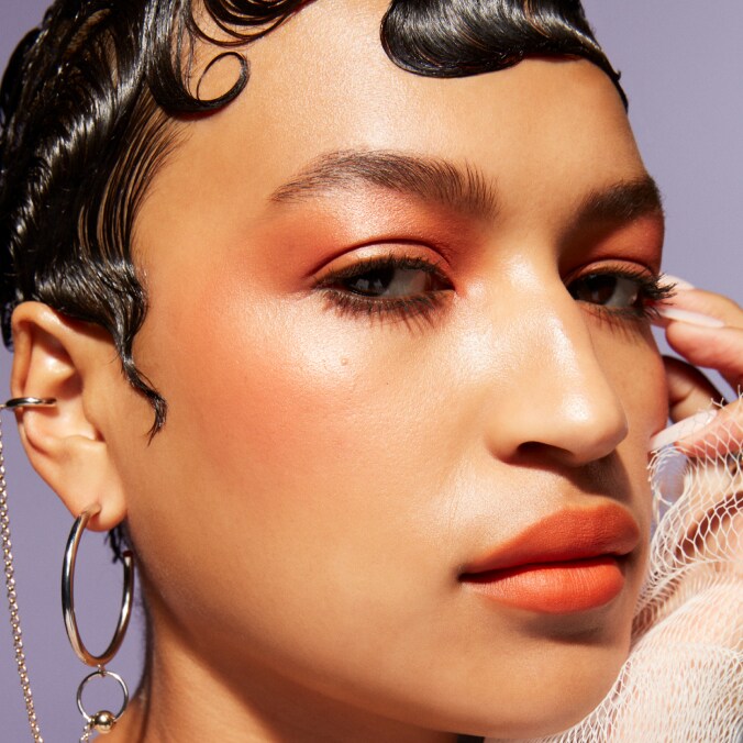 Model with MAC Cosmetics product.